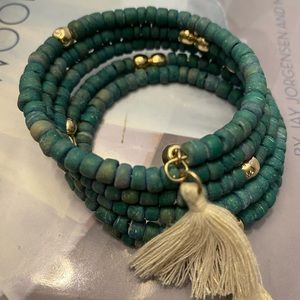 Turquoise color wood and gold tone bead coil bracelet